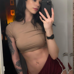 Red Bohemian Avant-Garde Cosplay Style with Bold V-Neck Top, Cropped Shorts, and Elegant Diamond Necklace